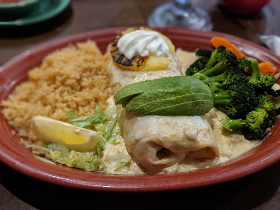 Printed menu with cocktails, burritos, and seafood.