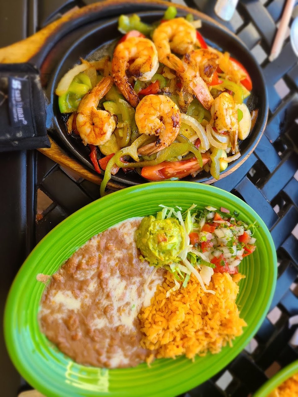 Printed menu with cocktails, burritos, and seafood.